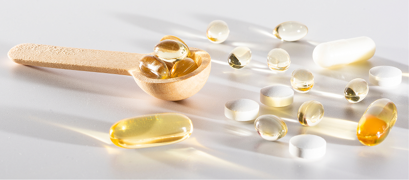 Gel capsules scattered on a surface. 
